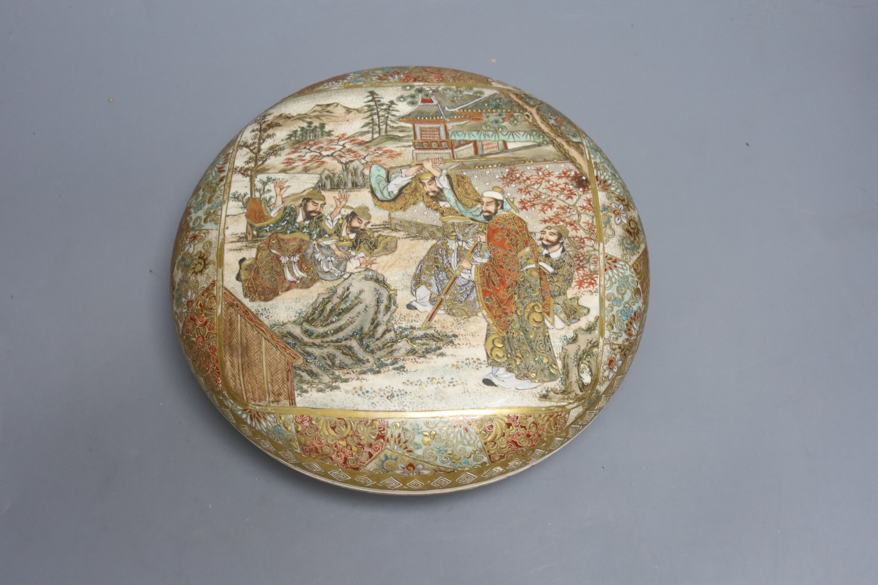 A late 19th century Japanese Satsuma box and cover, painted and gilded throughout, 23cm diameter